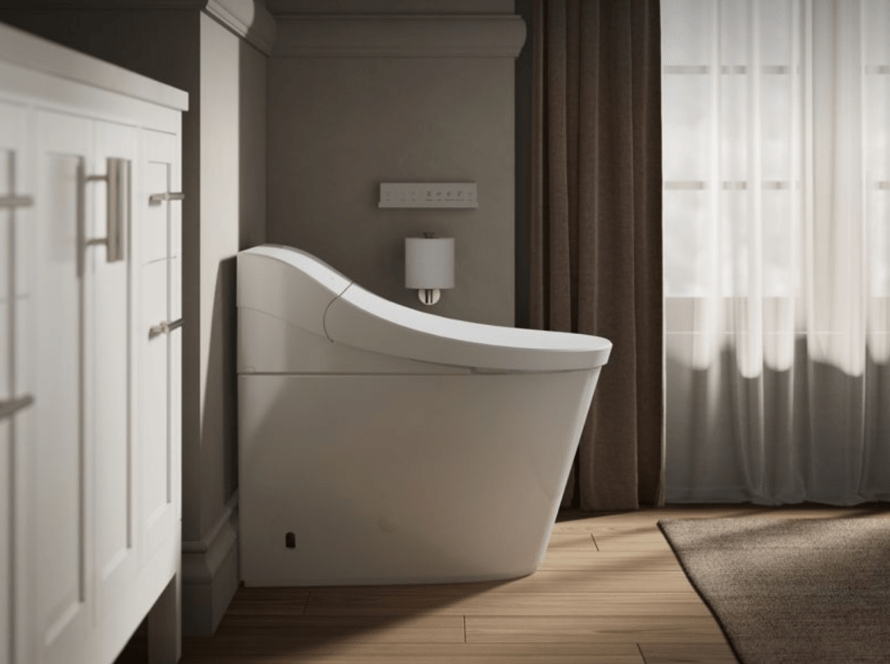 Modern Kohler smart toilet installed in a stylish bathroom corner, featuring sleek design, adjacent cabinetry, and a wall-mounted control panel.