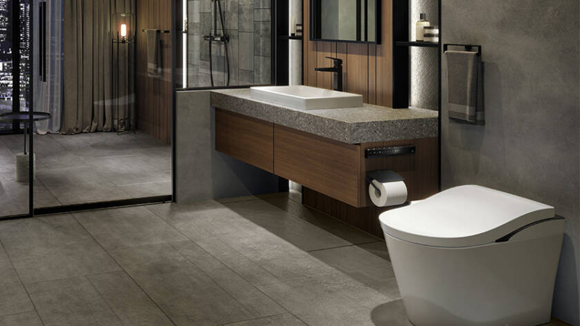 Modern bathroom featuring a sleek TOTO smart toilet, minimalist design, stone countertop, and contemporary fixtures, highlighting luxury and hygiene in smart home upgrades.