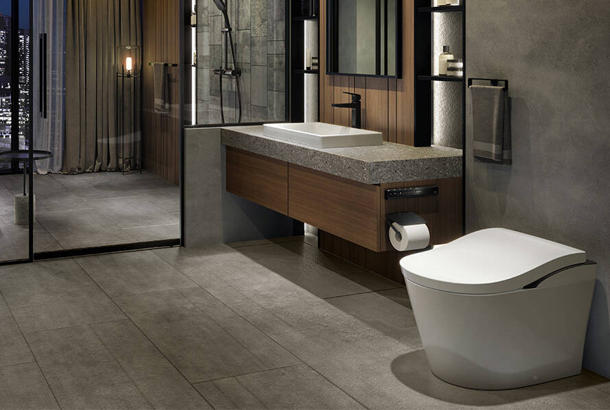 Modern bathroom featuring a sleek TOTO smart toilet, minimalist design with a stone sink and wooden cabinetry, emphasizing comfort and hygiene.