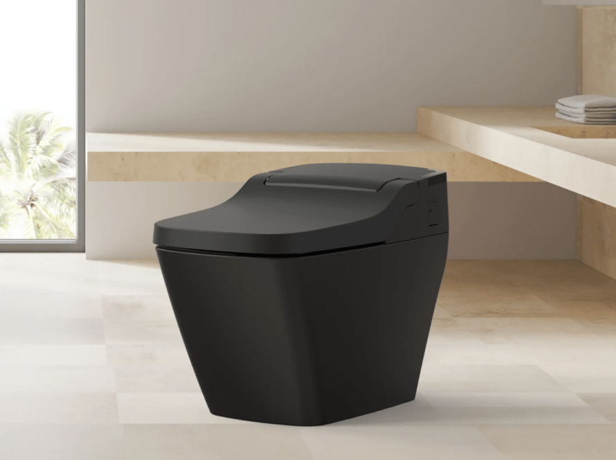 Modern black smart toilet in a stylish bathroom setting, emphasizing comfort and technology integration for enhanced bathroom experiences.