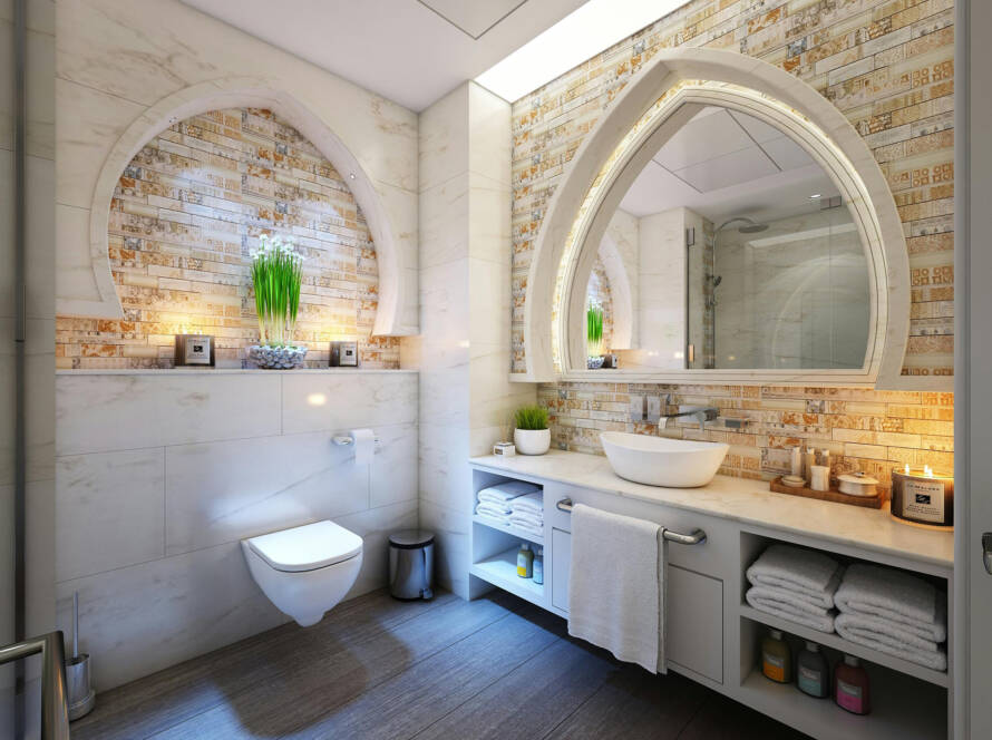 Modern bathroom featuring a sleek smart toilet, elegant vessel sink, decorative stone wall, and stylish lighting, emphasizing comfort and hygiene in home design.